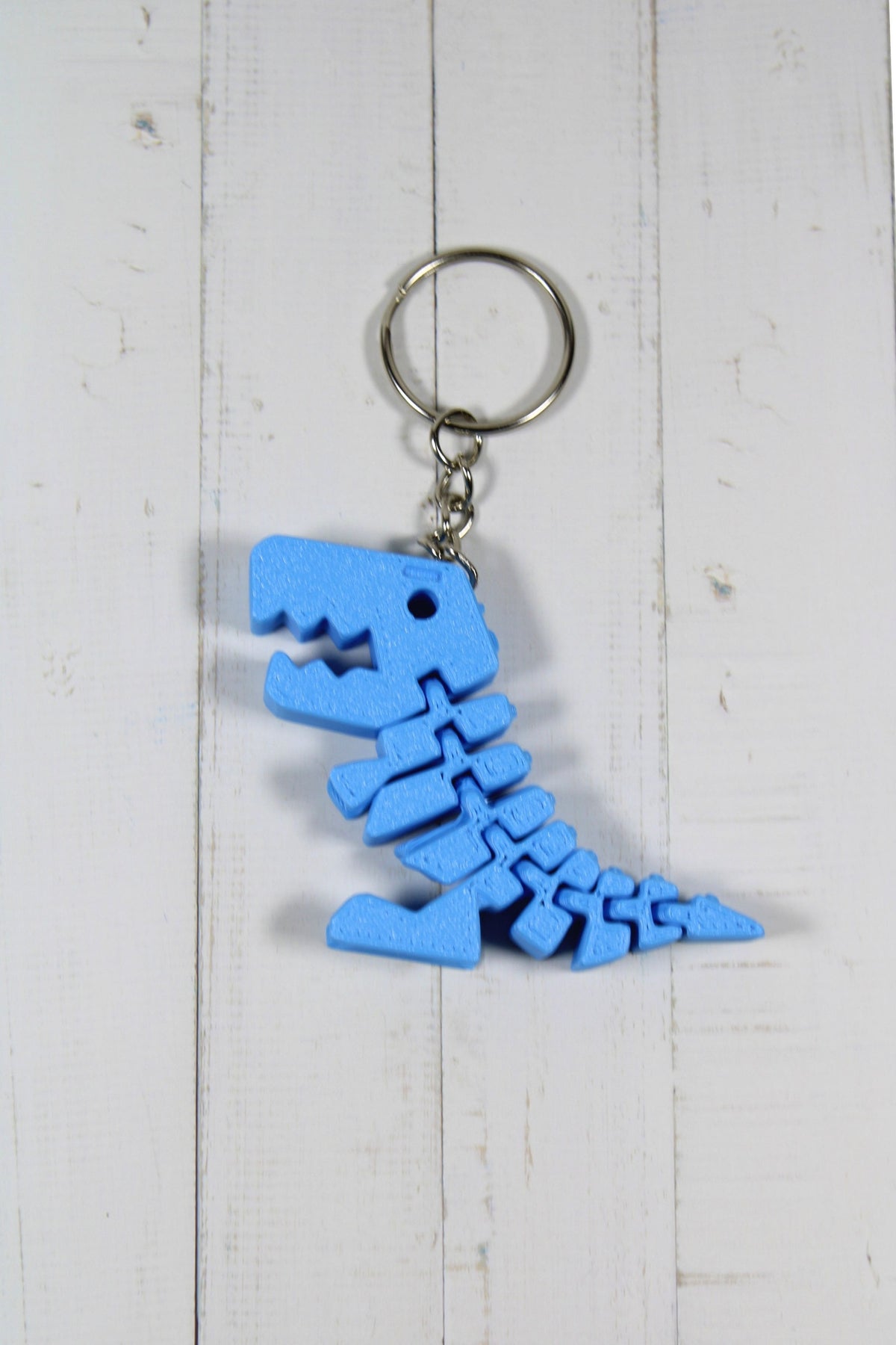 bleu.jpg
Porte-clé dinosaure articulé flexible bleu imprimé en 3D