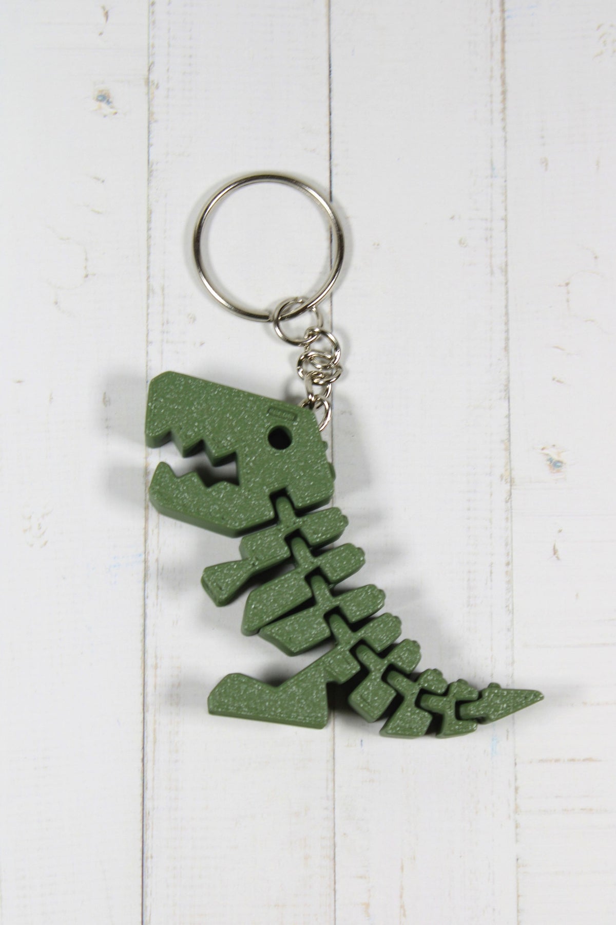 Porte-clé dinosaure articulé flexible vert imprimé en 3D