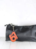 Porte-clé 67 rouge et noir accroché à une trousse