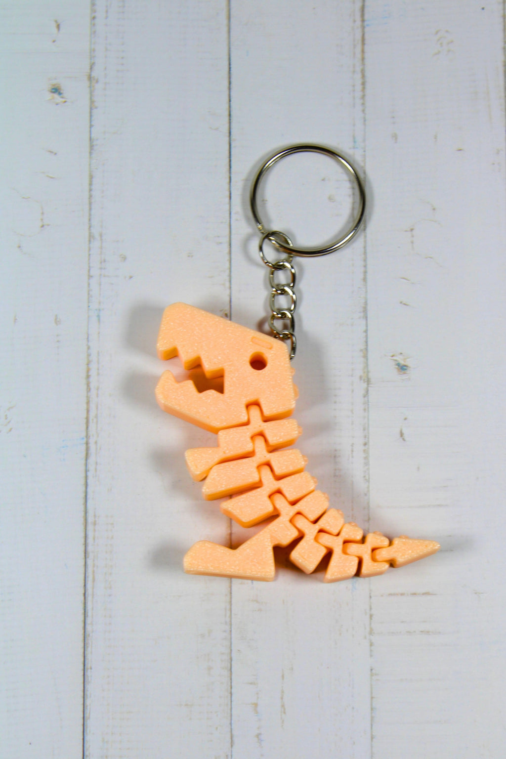 Porte-clé dinosaure articulé flexible orange imprimé en 3D