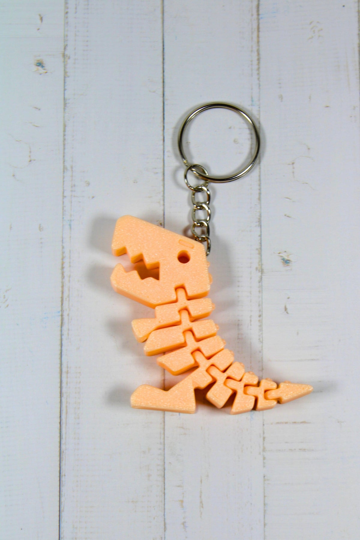Porte-clé dinosaure articulé flexible orange imprimé en 3D