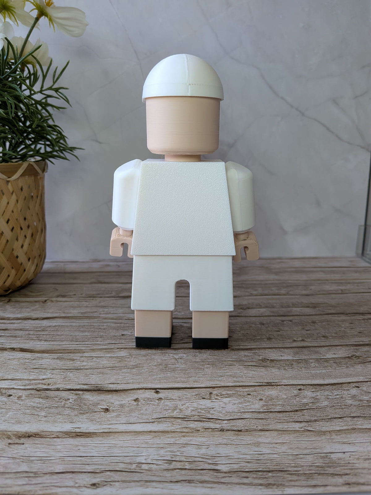 Dos de la figurine OM avec emplacement pour prénom et numéro