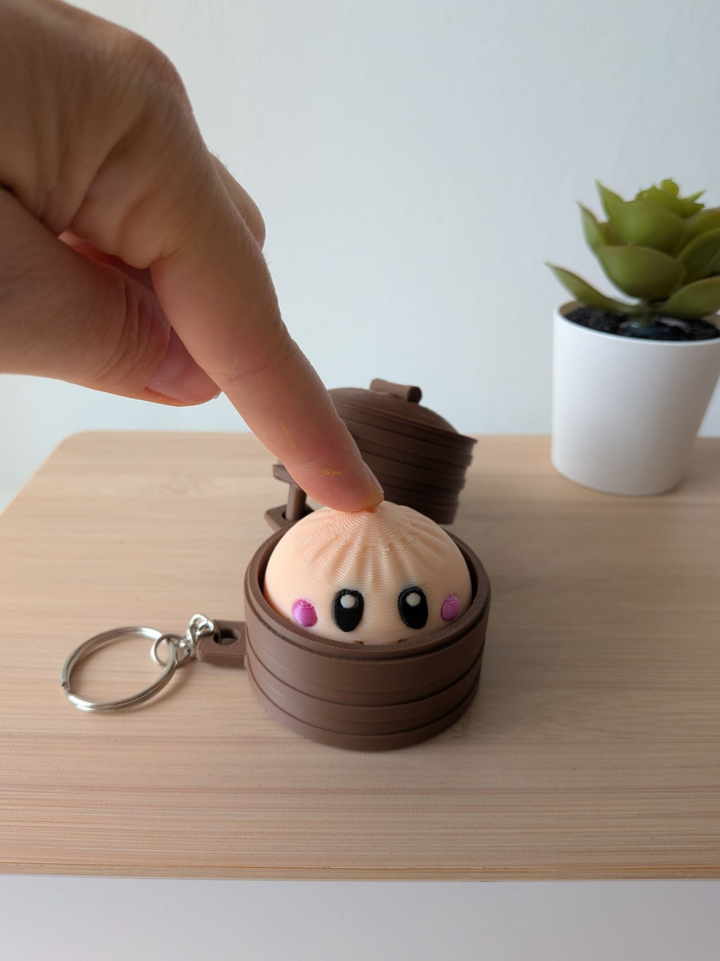 Porte-clés anti-stress kawaii avec clicker actionné en appuyant sur le personnage